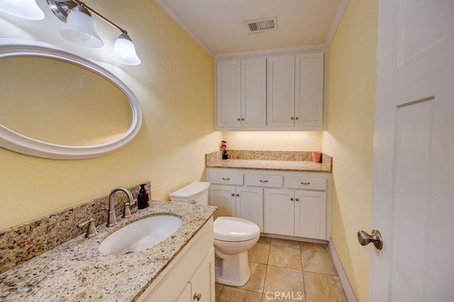 bathroom with crown molding, vanity, tile patterned flooring, and toilet