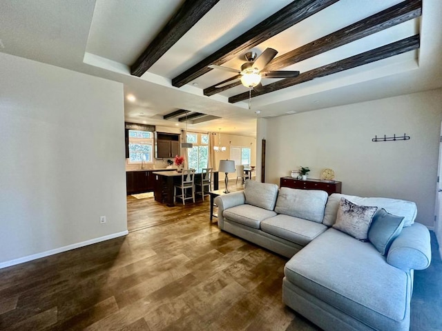 living room featuring ceiling fan, dark wood-type flooring, and sink