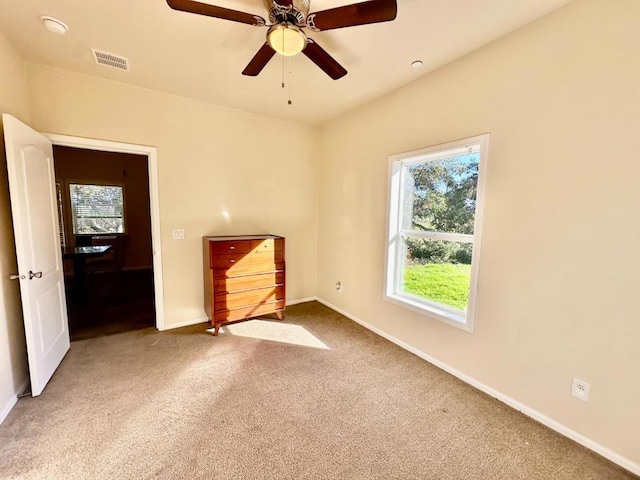 unfurnished bedroom with ceiling fan and carpet flooring