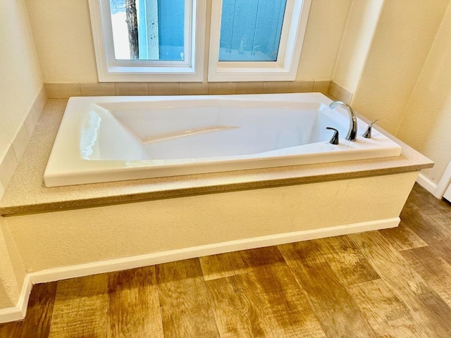 bathroom featuring hardwood / wood-style floors and a bathing tub