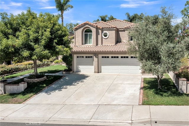 mediterranean / spanish home with a garage