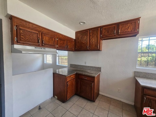 kitchen with light tile patterned floors and a textured ceiling