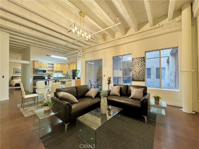 interior space featuring beam ceiling and a chandelier