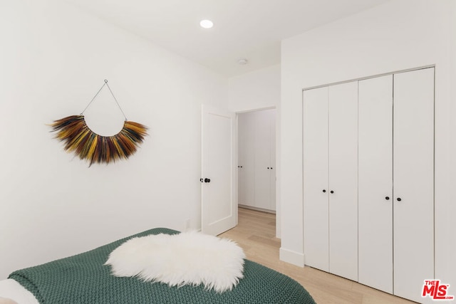 bedroom featuring light hardwood / wood-style floors and a closet