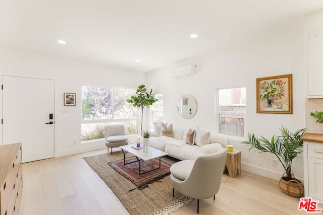 living room with light hardwood / wood-style flooring and a wall mounted air conditioner