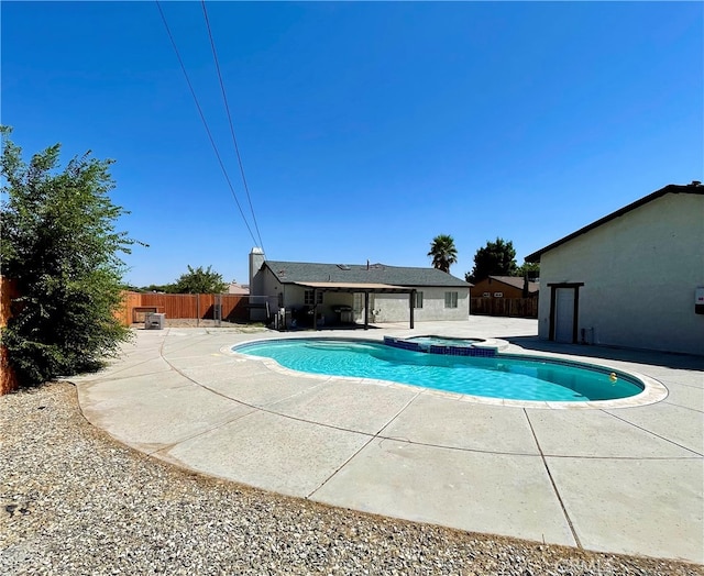 view of pool featuring an in ground hot tub and a patio area