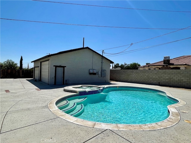 view of swimming pool with a patio and an in ground hot tub