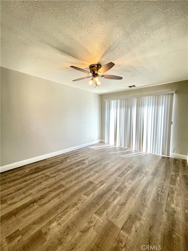 unfurnished room with a textured ceiling, hardwood / wood-style flooring, and ceiling fan