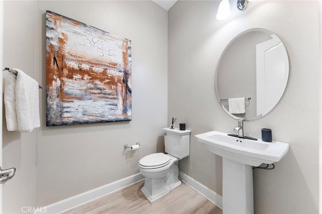 bathroom with wood-type flooring and toilet