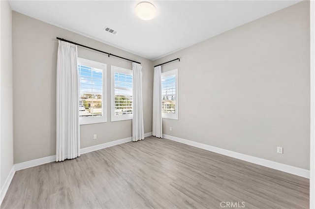 unfurnished room featuring light wood-type flooring