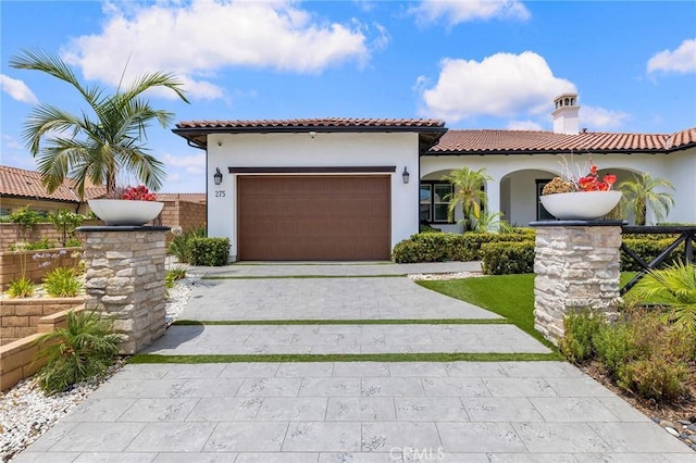 mediterranean / spanish-style home with a garage