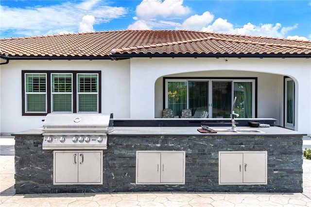 view of patio with area for grilling, sink, and grilling area