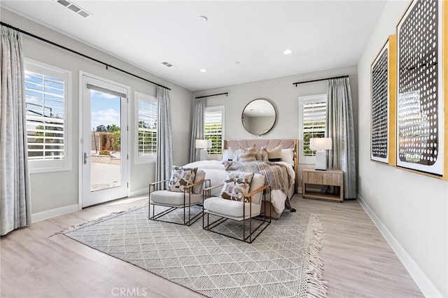 bedroom featuring access to outside and light hardwood / wood-style floors