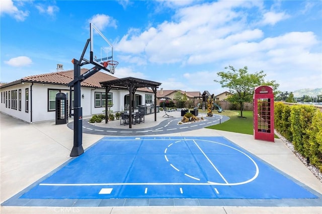 view of basketball court featuring a pergola and a playground