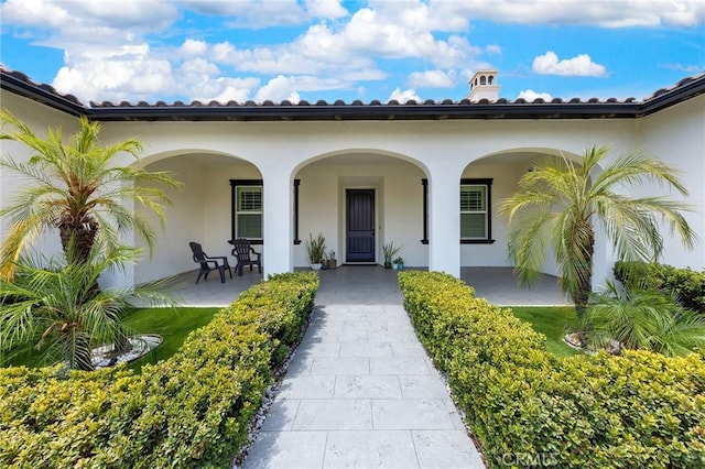 view of exterior entry with a porch