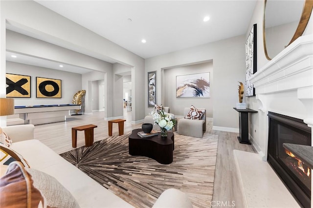 living room with light hardwood / wood-style floors and pool table