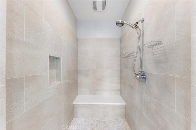 bathroom with a tile shower