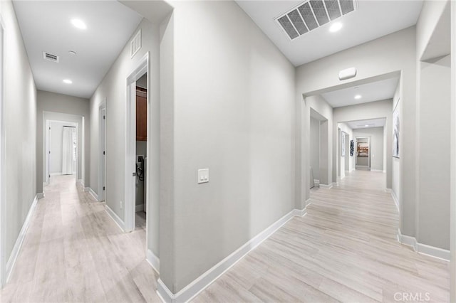 hall with light hardwood / wood-style floors