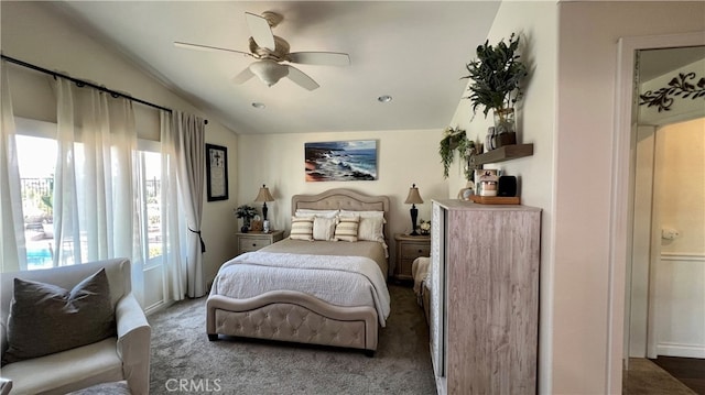 carpeted bedroom with ceiling fan and lofted ceiling