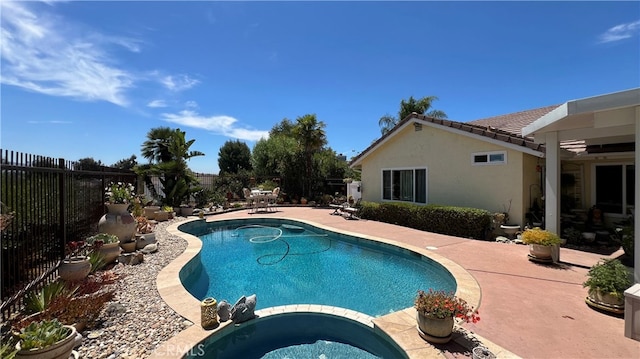 view of swimming pool with an in ground hot tub and a patio