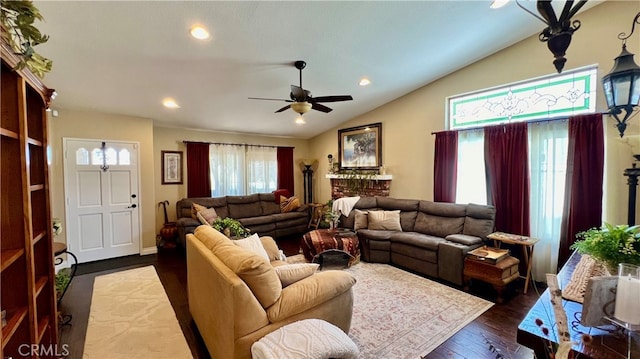 living room with ceiling fan, plenty of natural light, dark wood-type flooring, and lofted ceiling