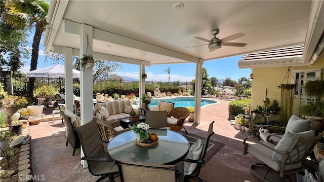 view of patio with ceiling fan, an outdoor living space, and a fenced in pool