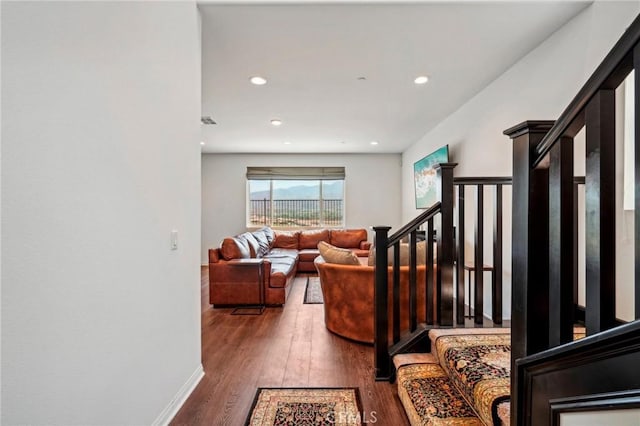 interior space with baseboards, stairway, wood finished floors, and recessed lighting