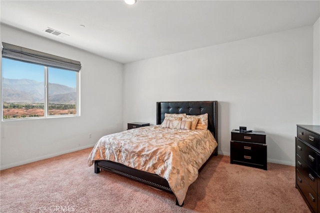 bedroom featuring a mountain view and light colored carpet