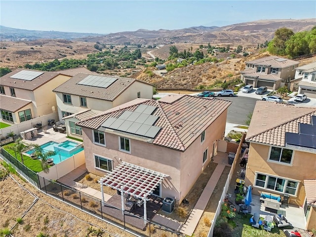 drone / aerial view featuring a residential view and a mountain view