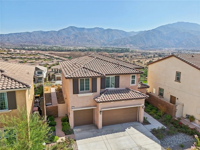 mediterranean / spanish-style home featuring a garage and a mountain view