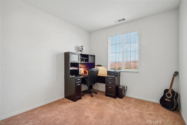 office area featuring light carpet, baseboards, and visible vents