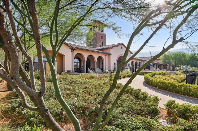 mediterranean / spanish-style house with a tile roof and stucco siding