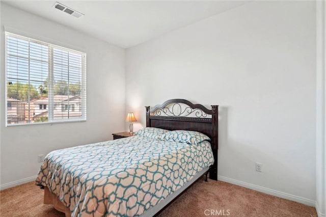 bedroom featuring carpet floors, visible vents, and baseboards