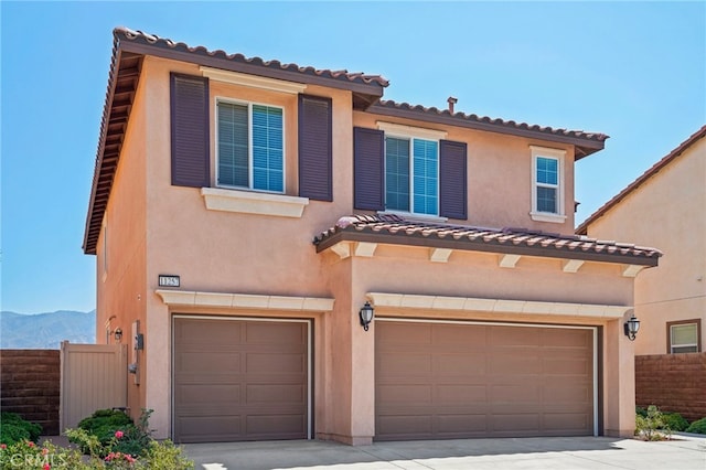 mediterranean / spanish-style home featuring a mountain view and a garage