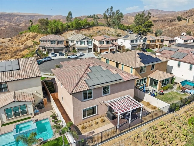 birds eye view of property with a mountain view and a residential view