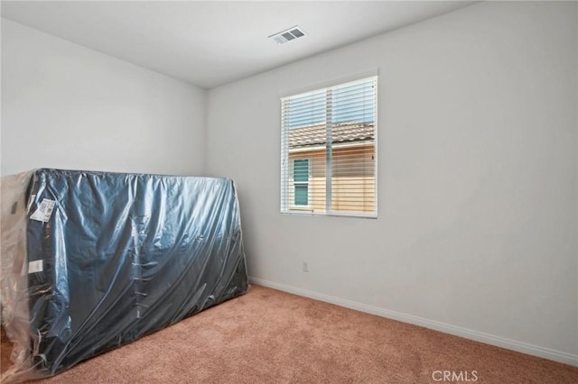 bedroom featuring carpet floors, visible vents, and baseboards