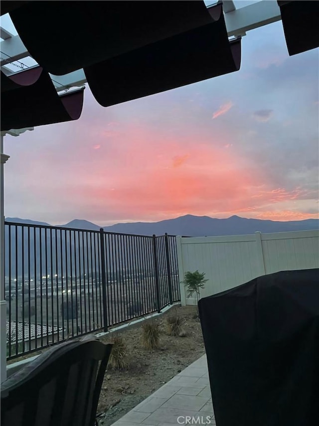 view of yard featuring a mountain view and fence