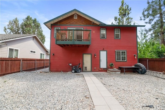 rear view of property featuring a patio area and a balcony