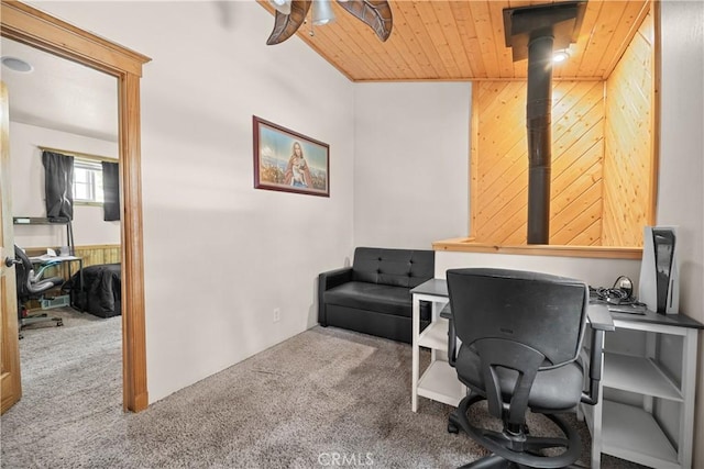 carpeted home office featuring lofted ceiling, wood walls, and wooden ceiling