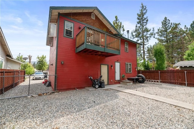 back of property with a balcony