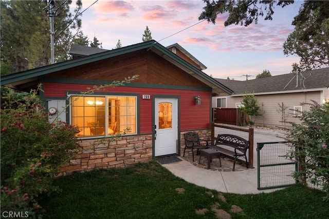 back house at dusk with a patio