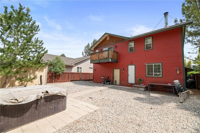 back of house featuring a patio area and a balcony