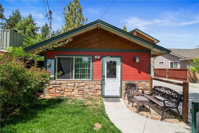 view of front of house with a patio and a front lawn