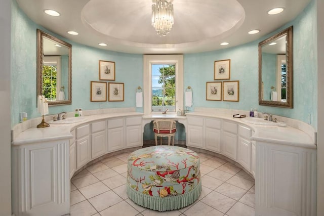 bathroom featuring tile patterned flooring, a raised ceiling, and a healthy amount of sunlight