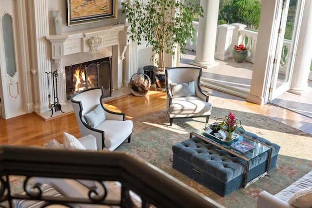 living area featuring wood-type flooring and a premium fireplace