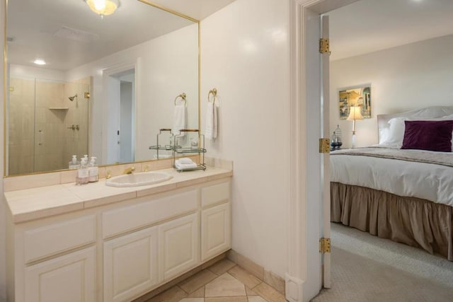 bathroom featuring a shower with door, vanity, and tile patterned flooring