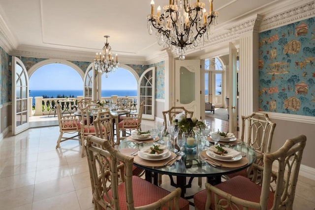 dining room featuring french doors, a water view, a chandelier, and ornamental molding