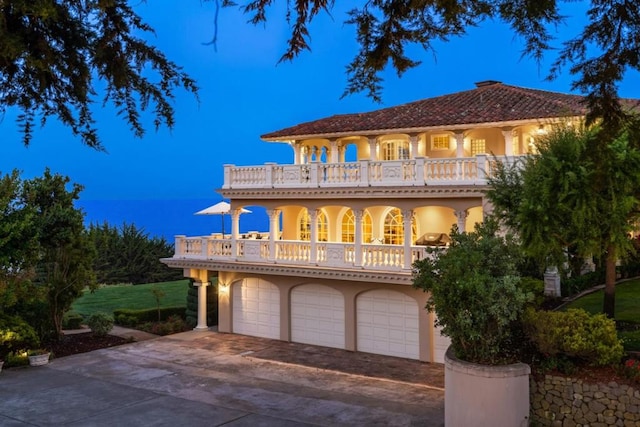 mediterranean / spanish home with a garage and a balcony