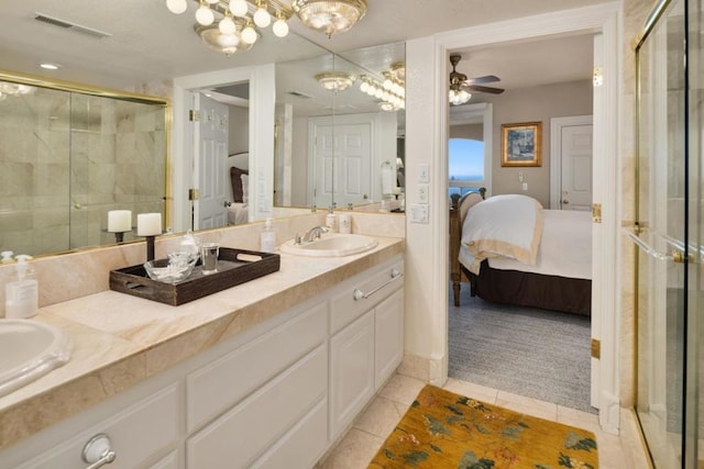 bathroom featuring vanity, a shower with door, tile patterned floors, and ceiling fan