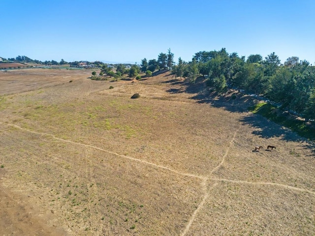 birds eye view of property with a rural view